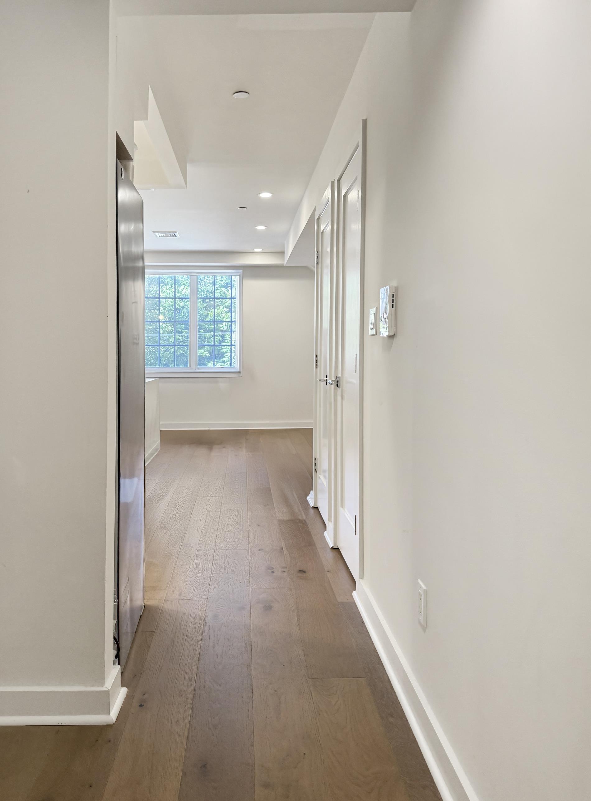 31-22 29th Street, Unit 2B Queens, NY 11106 - Photo 7 of 11 a view of hallway with wooden floor