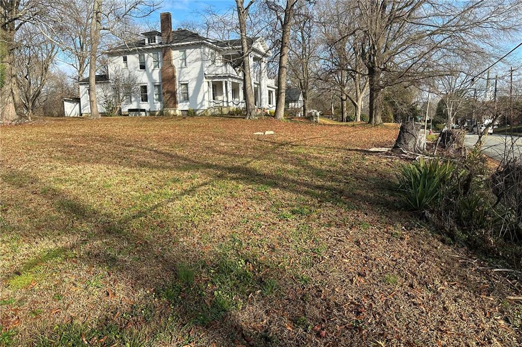 709 West Davis Street Rockingham, NC 28379 - Photo 3 of 13 a view of a large house with a yard covered with snow
