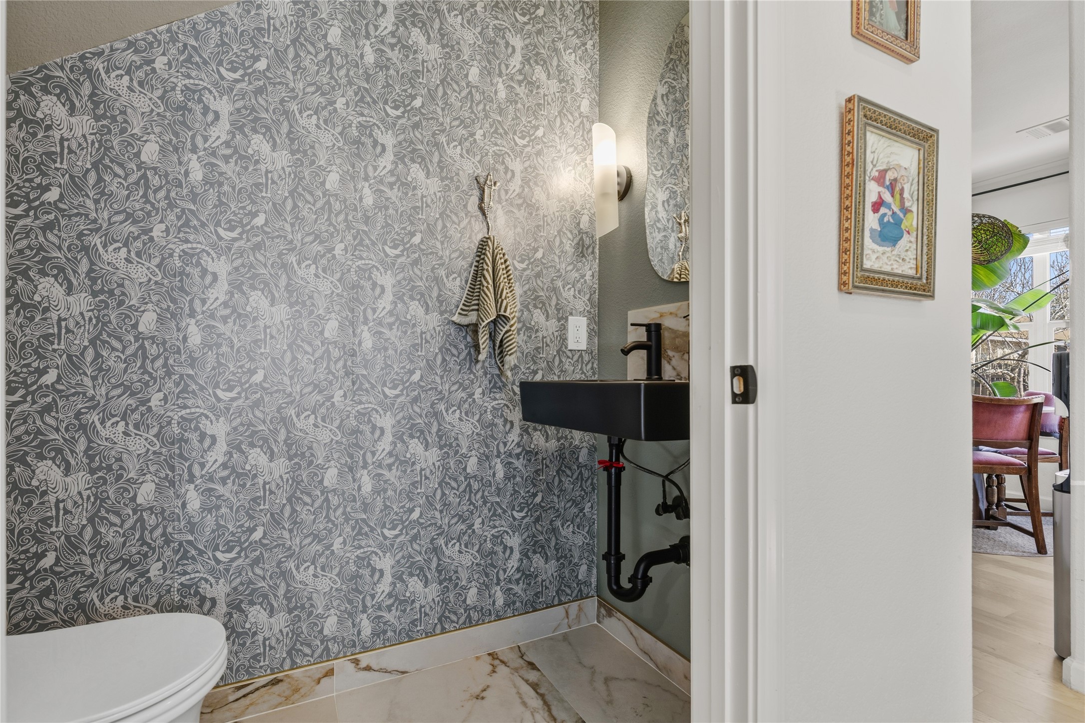 7400 South Glenn Street Austin, TX 78744 - Photo 12 of 36 Bathroom featuring toilet and light marble finish floors