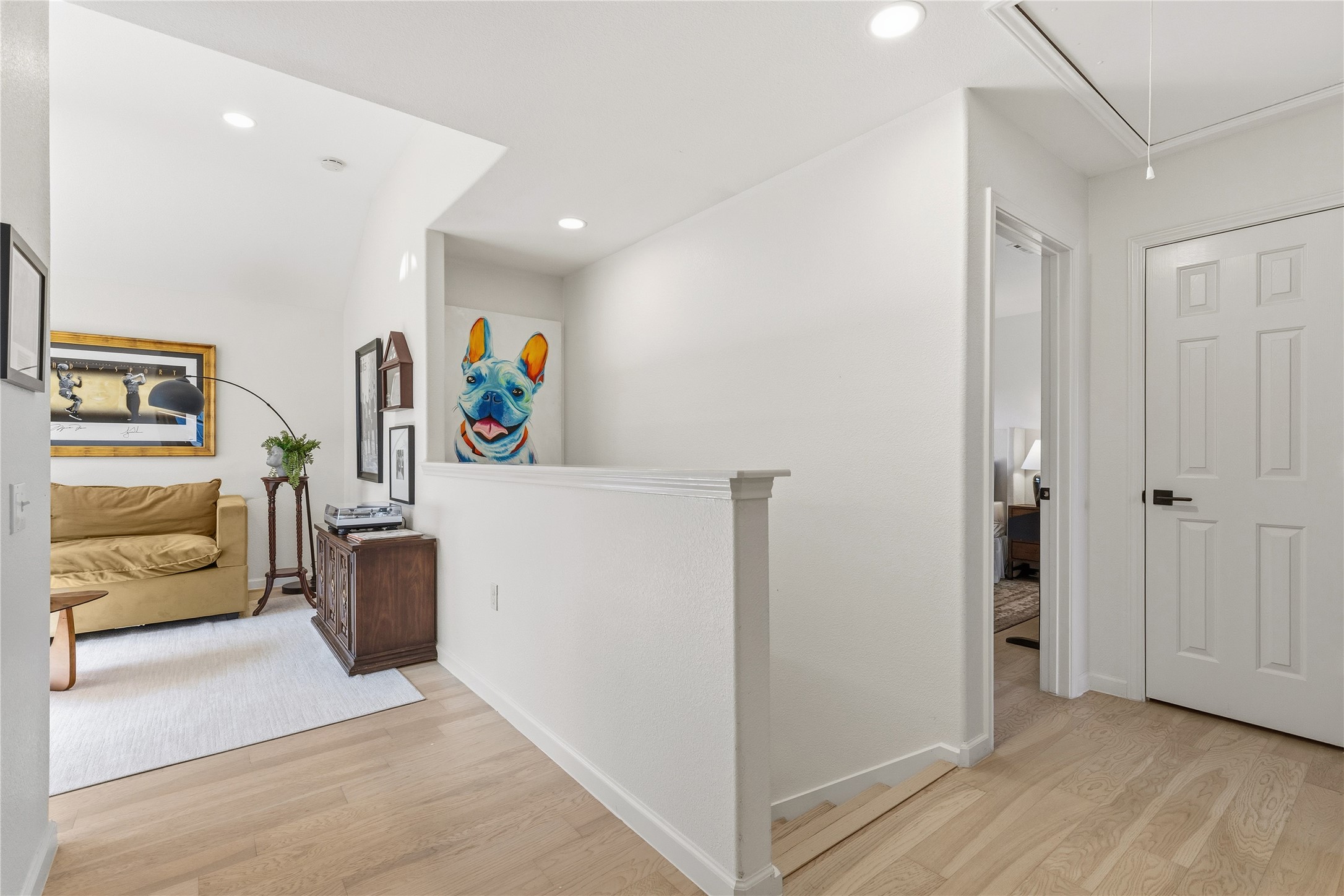 7400 South Glenn Street Austin, TX 78744 - Photo 21 of 36 Hall with light wood-style flooring, recessed lighting, and an upstairs landing