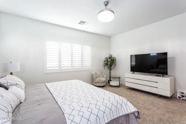 a spacious bedroom with a bed and a couch