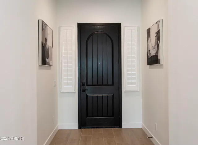 a large kitchen with stainless steel appliances kitchen island granite countertop a refrigerator a oven and a wooden floors