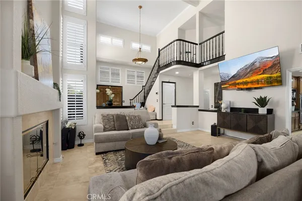 a kitchen with granite countertop kitchen island stainless steel appliances a refrigerator a sink a stove a dining table and chairs