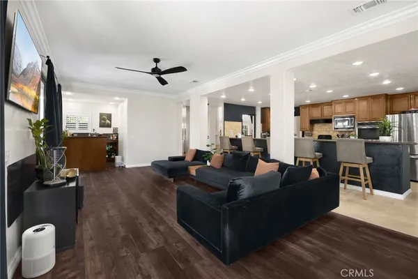 a kitchen with stainless steel appliances granite countertop sink a refrigerator and wooden floor