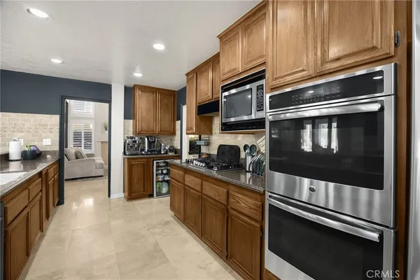 a large kitchen with a large counter top appliances and cabinets