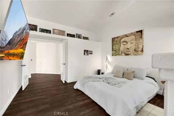 a large white room with mirror and furniture