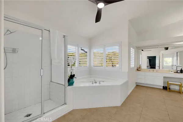 a bathroom with a double vanity sink mirror and shower