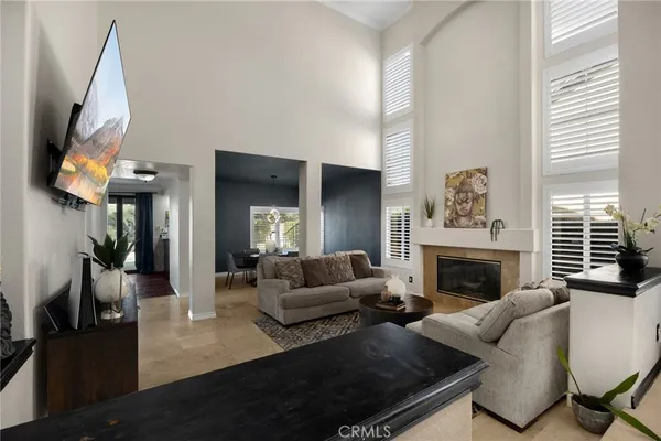 a living room with furniture a large window and a fireplace
