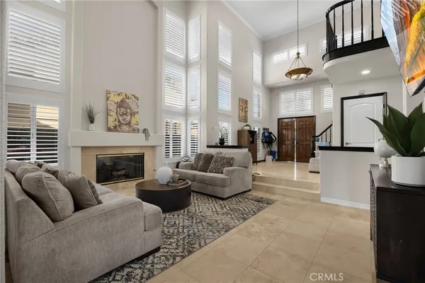 a living room with furniture kitchen view and a flat screen tv