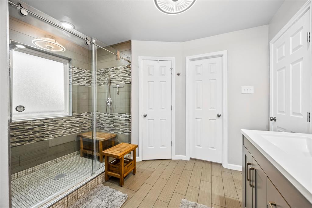 909 Valley View Avenue Red Oak, TX 75154 - Photo 23 of 37 a en suite bathroom with a granite countertop tub sink and a shower