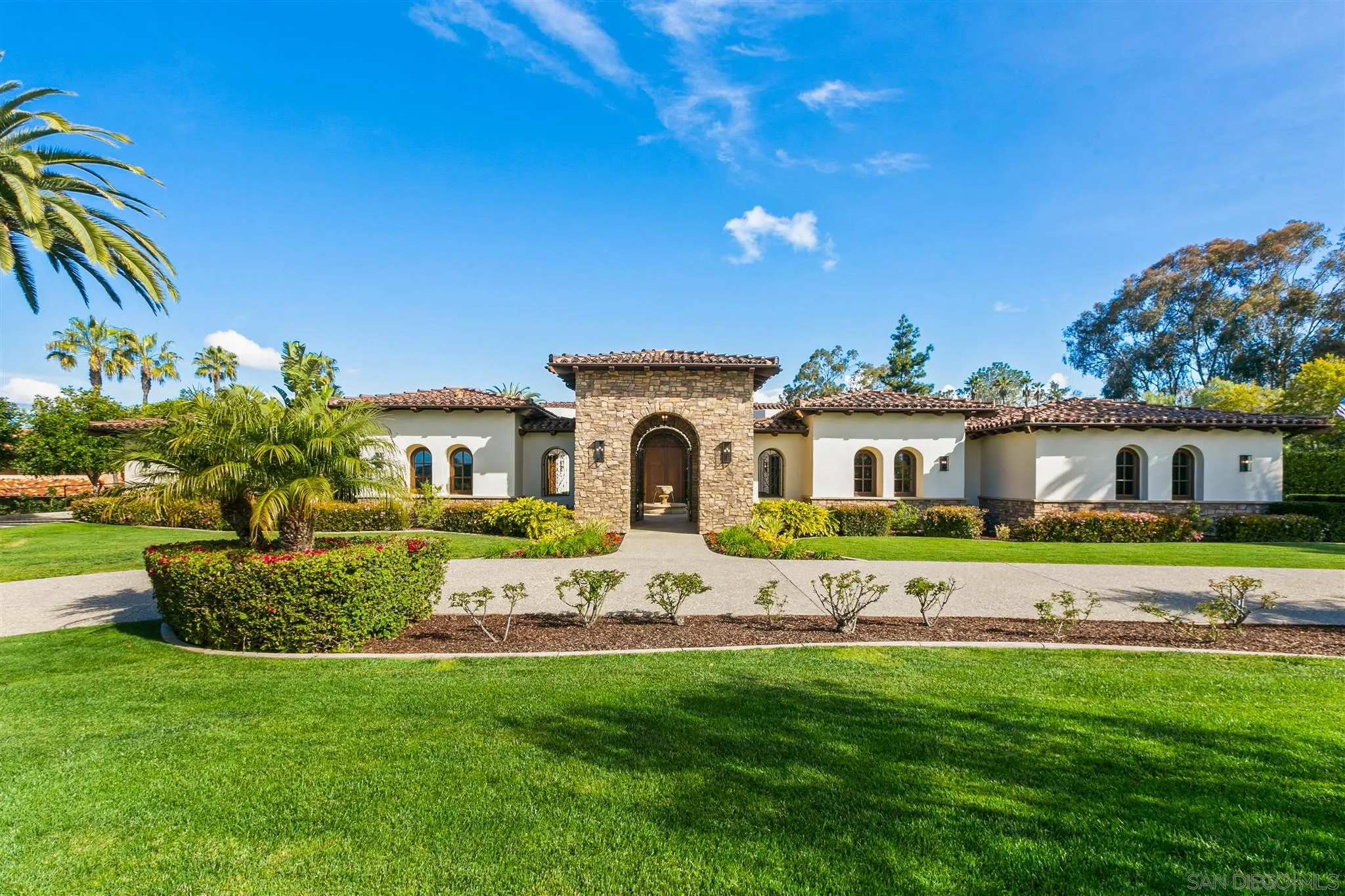 6658 Niemann Ranch Road Rancho Santa Fe, CA 92067 - Photo 1 of 35 a front view of a house with a garden