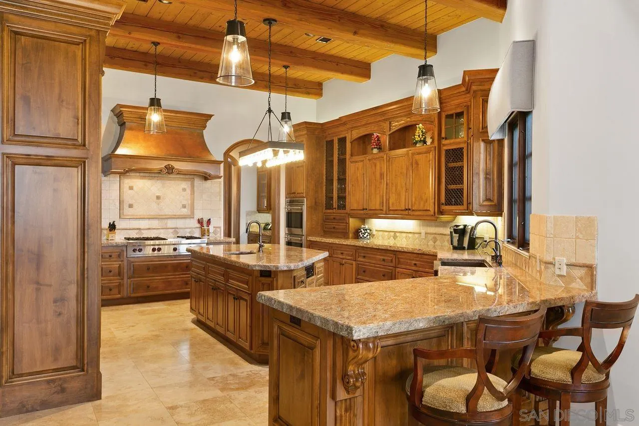 6658 Niemann Ranch Road Rancho Santa Fe, CA 92067 - Photo 17 of 35 a kitchen with cabinets and refrigerator