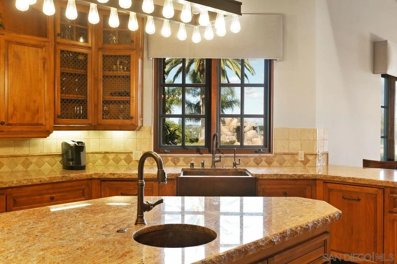 6658 Niemann Ranch Road Rancho Santa Fe, CA 92067 - Photo 19 of 35 a kitchen with a sink and a large window