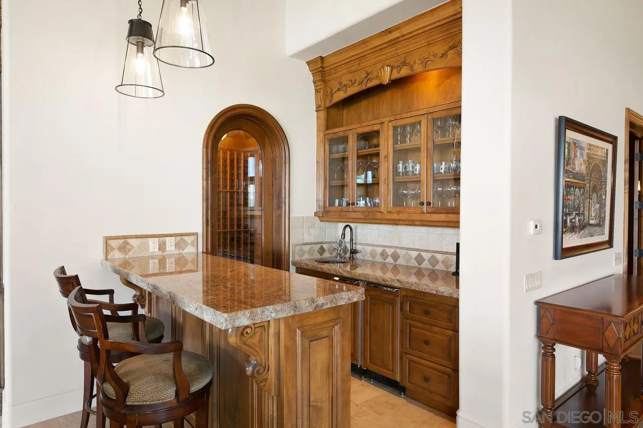 6658 Niemann Ranch Road Rancho Santa Fe, CA 92067 - Photo 21 of 35 a dining table chair with a granite countertop next to a window