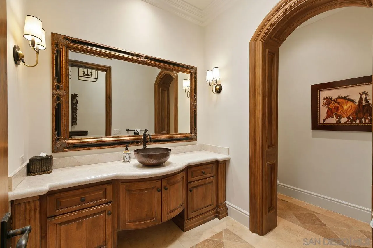 6658 Niemann Ranch Road Rancho Santa Fe, CA 92067 - Photo 22 of 35 a bathroom with a double vanity sink and a mirror