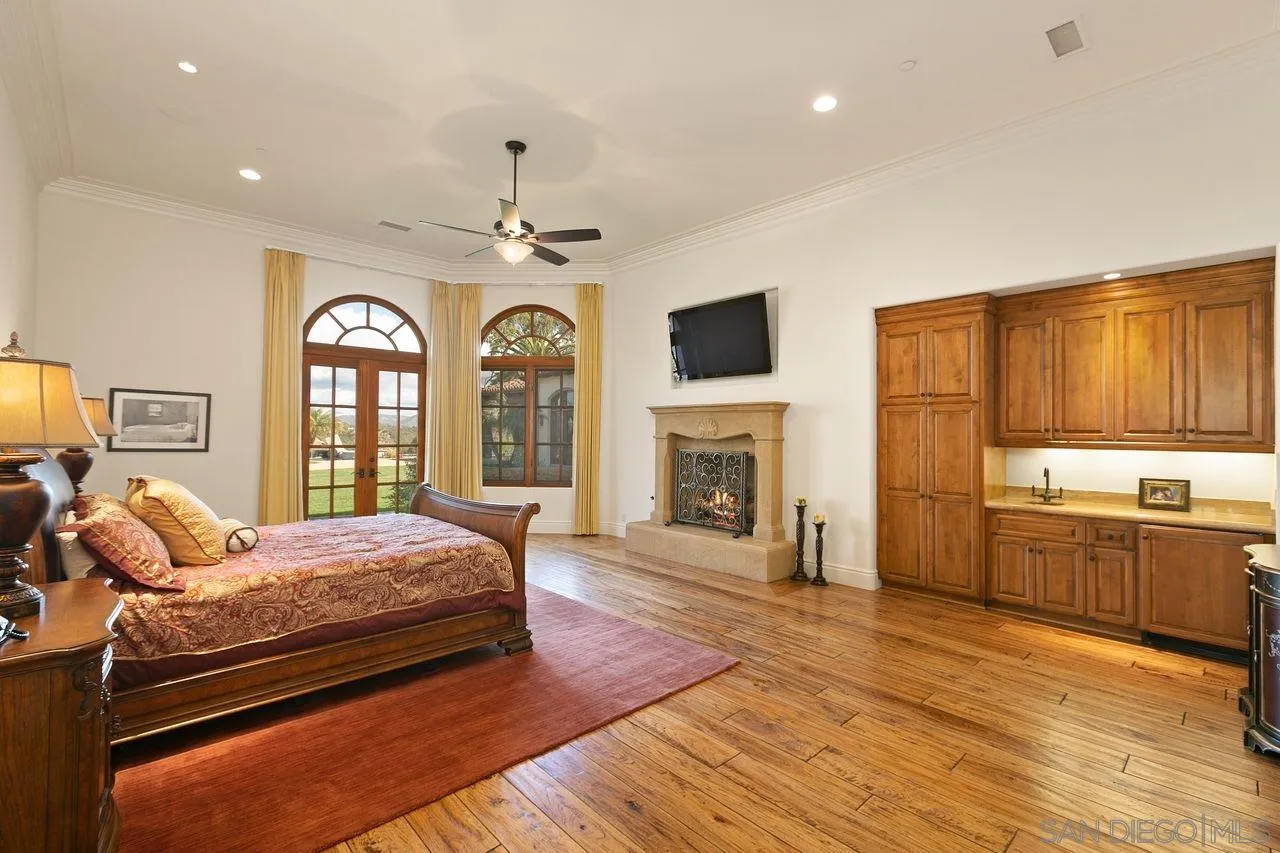 6658 Niemann Ranch Road Rancho Santa Fe, CA 92067 - Photo 23 of 35 a bedroom with a bed and a fireplace