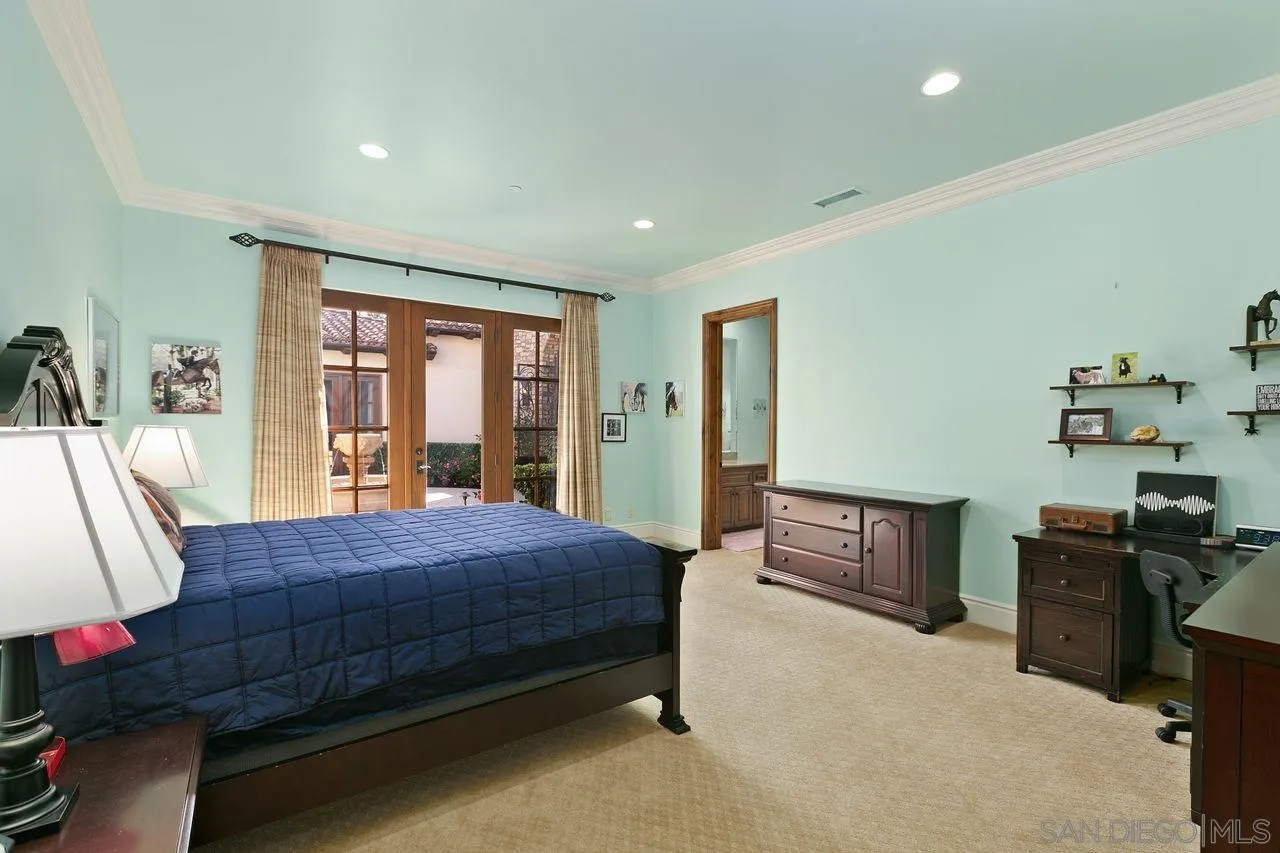 6658 Niemann Ranch Road Rancho Santa Fe, CA 92067 - Photo 25 of 35 a bedroom with a bed dresser and a large window