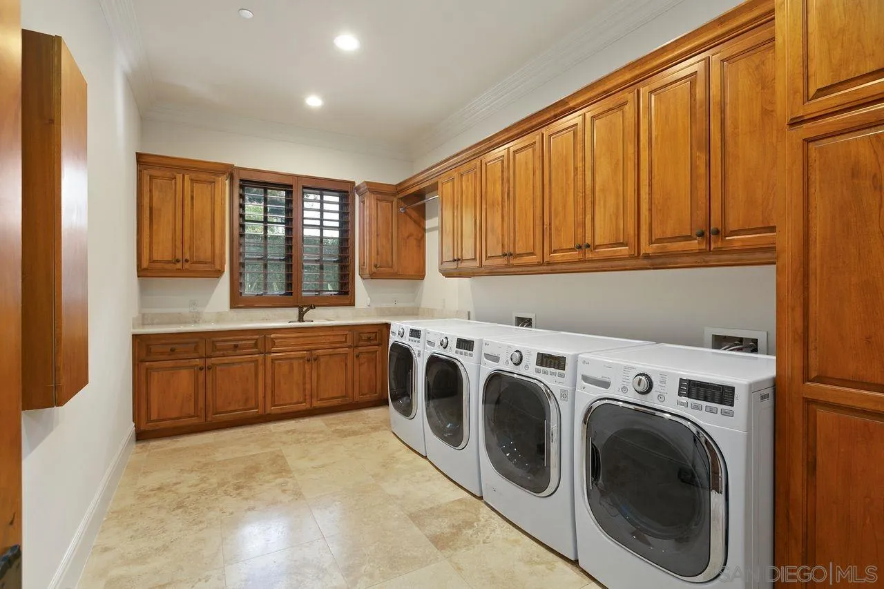 6658 Niemann Ranch Road Rancho Santa Fe, CA 92067 - Photo 29 of 35 a utility room with sink washer and dryer