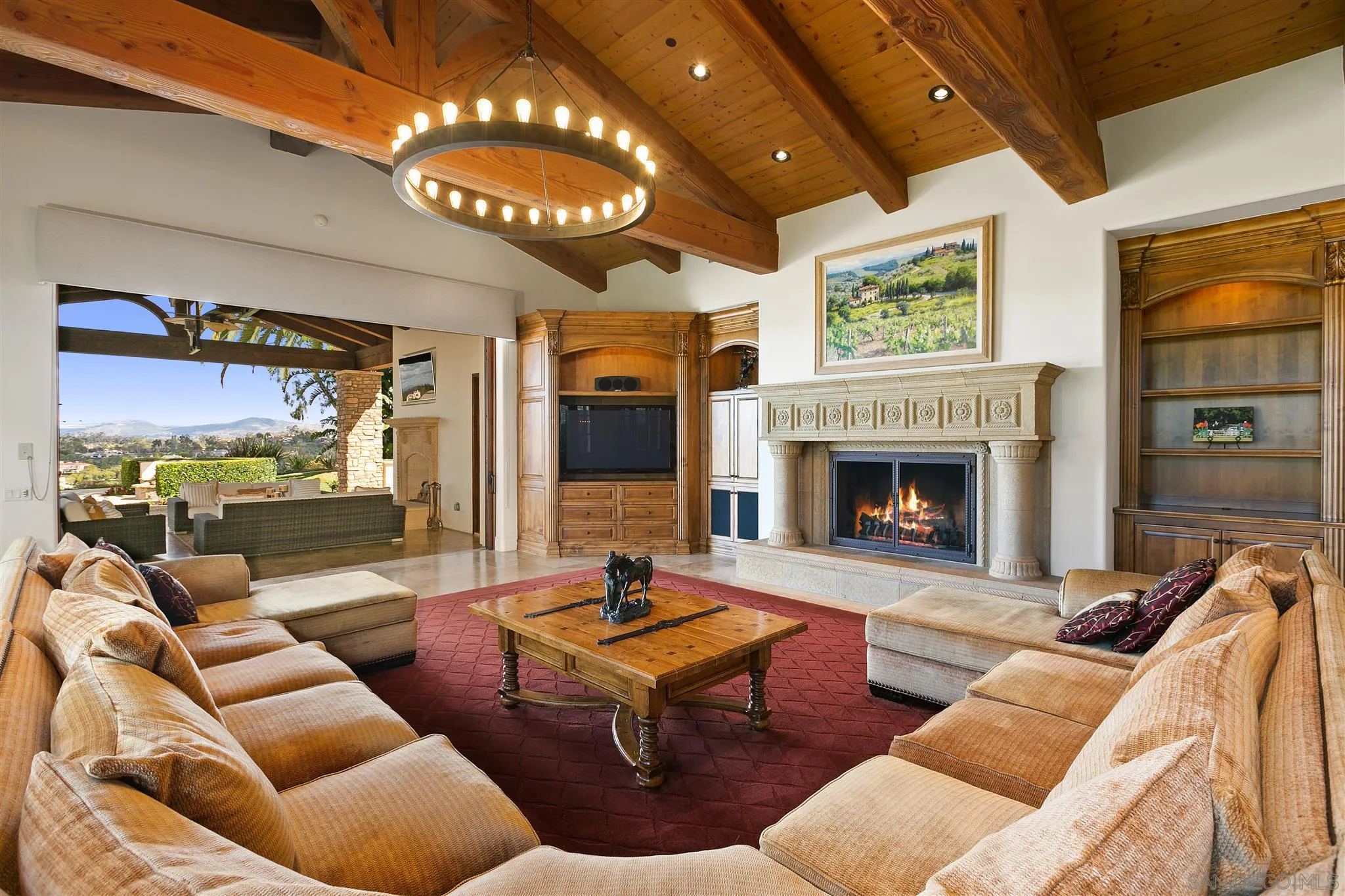 6658 Niemann Ranch Road Rancho Santa Fe, CA 92067 - Photo 3 of 35 a living room with furniture a large window and a fireplace