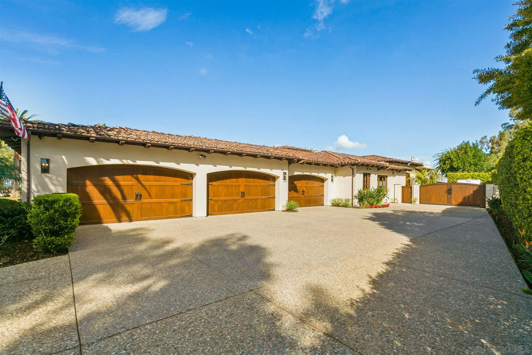 6658 Niemann Ranch Road Rancho Santa Fe, CA 92067 - Photo 31 of 35 a front view of a house with a yard and garage