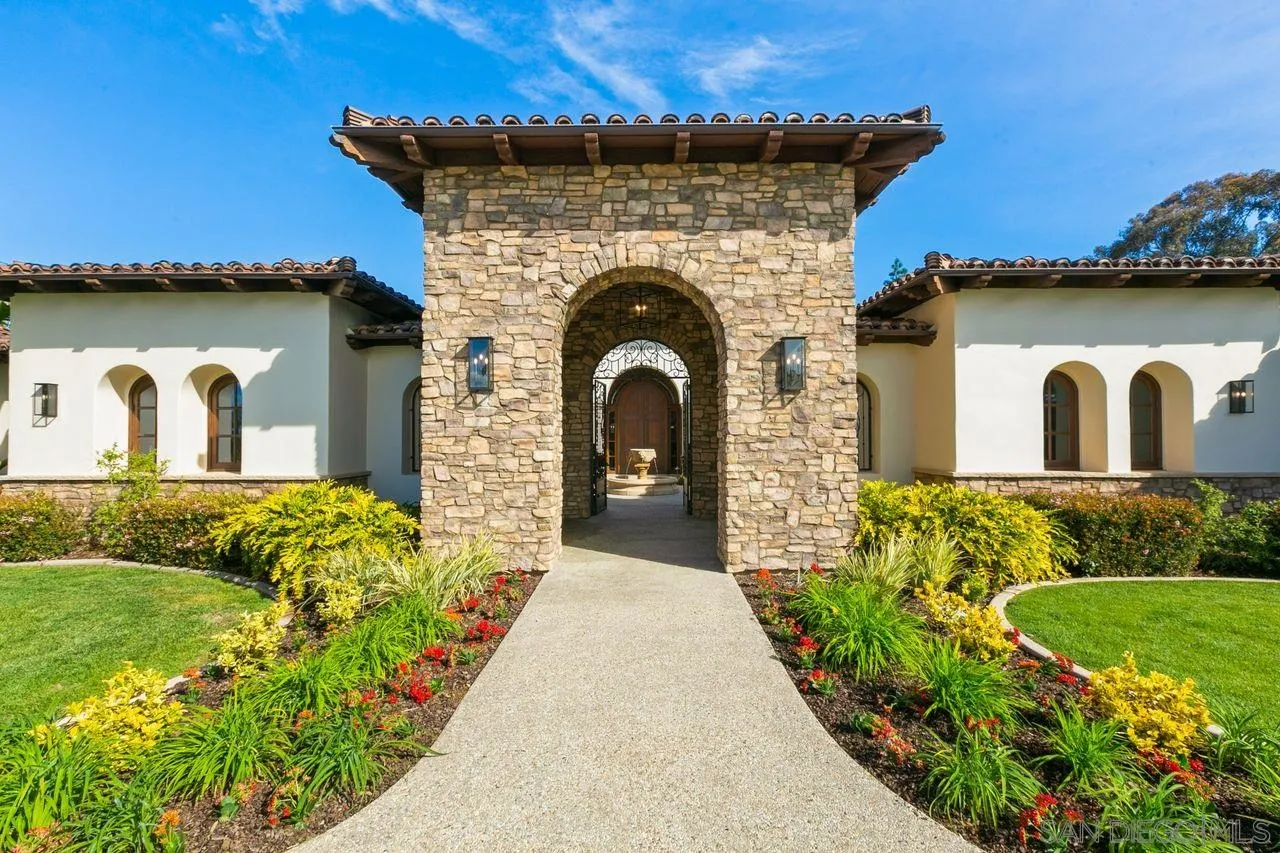 6658 Niemann Ranch Road Rancho Santa Fe, CA 92067 - Photo 7 of 35 a front view of a house with a garden