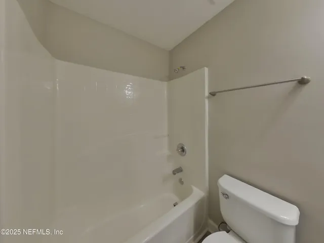 a bathroom with a toilet and a bathtub
