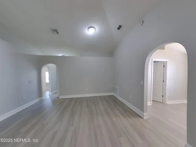 a view of room with window and wooden floor