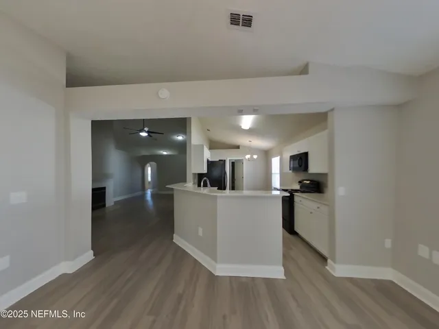 a kitchen with stainless steel appliances a refrigerator and a stove top oven