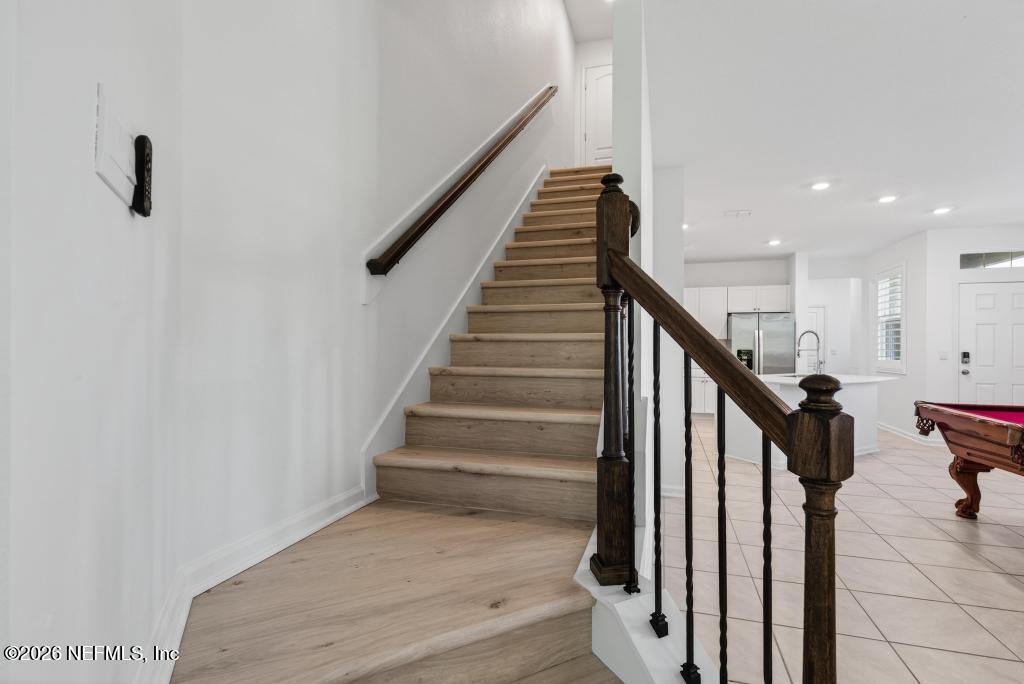 45 Seaport Breeze Road St. Augustine, FL 32095 - Photo 38 of 88 a view of staircase with lots of frames on wall and stairs
