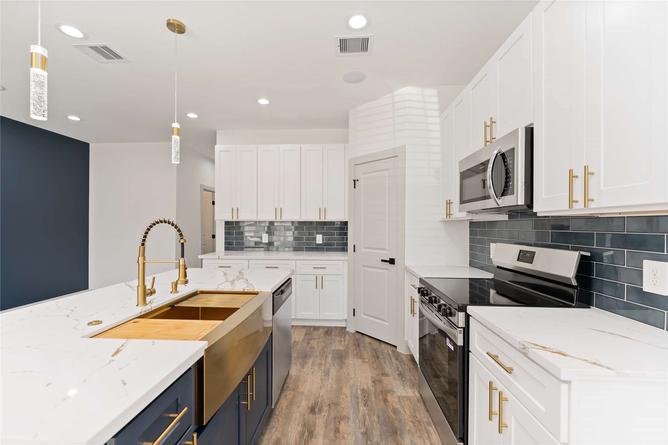 a kitchen with a sink a stove and cabinets