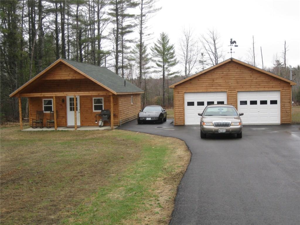 Beautiful log sided home and garage.