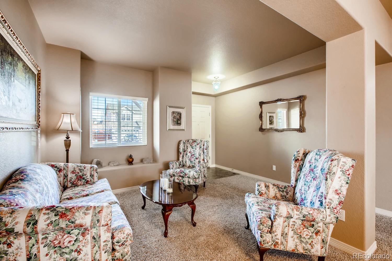 2184 Reed Grass Way Colorado Springs, CO 80915 - Photo 11 of 29 a living room with furniture and a large window
