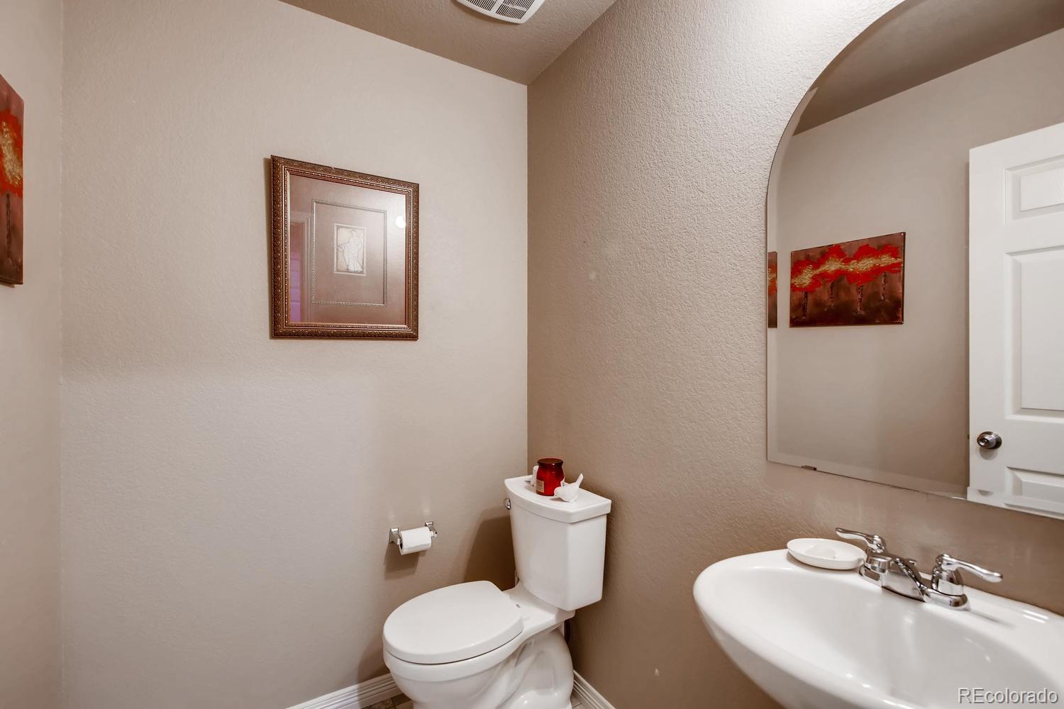 2184 Reed Grass Way Colorado Springs, CO 80915 - Photo 13 of 29 a bathroom with a toilet a sink and mirror