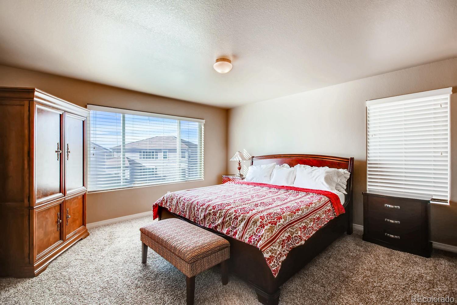2184 Reed Grass Way Colorado Springs, CO 80915 - Photo 17 of 29 a bedroom with a bed and a large window