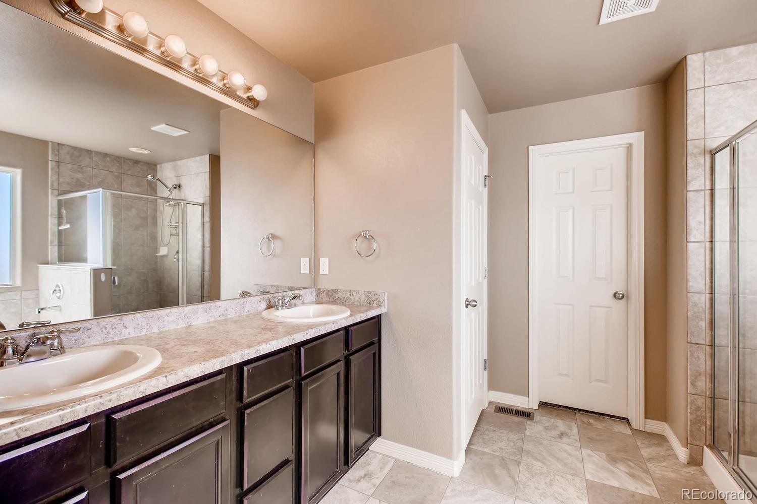 2184 Reed Grass Way Colorado Springs, CO 80915 - Photo 18 of 29 a bathroom with a sink double vanity and a mirror