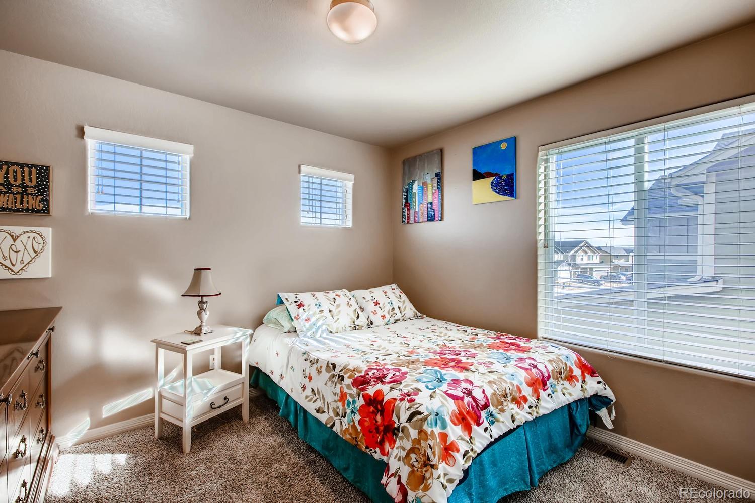 2184 Reed Grass Way Colorado Springs, CO 80915 - Photo 22 of 29 a bedroom with a bed chair and window