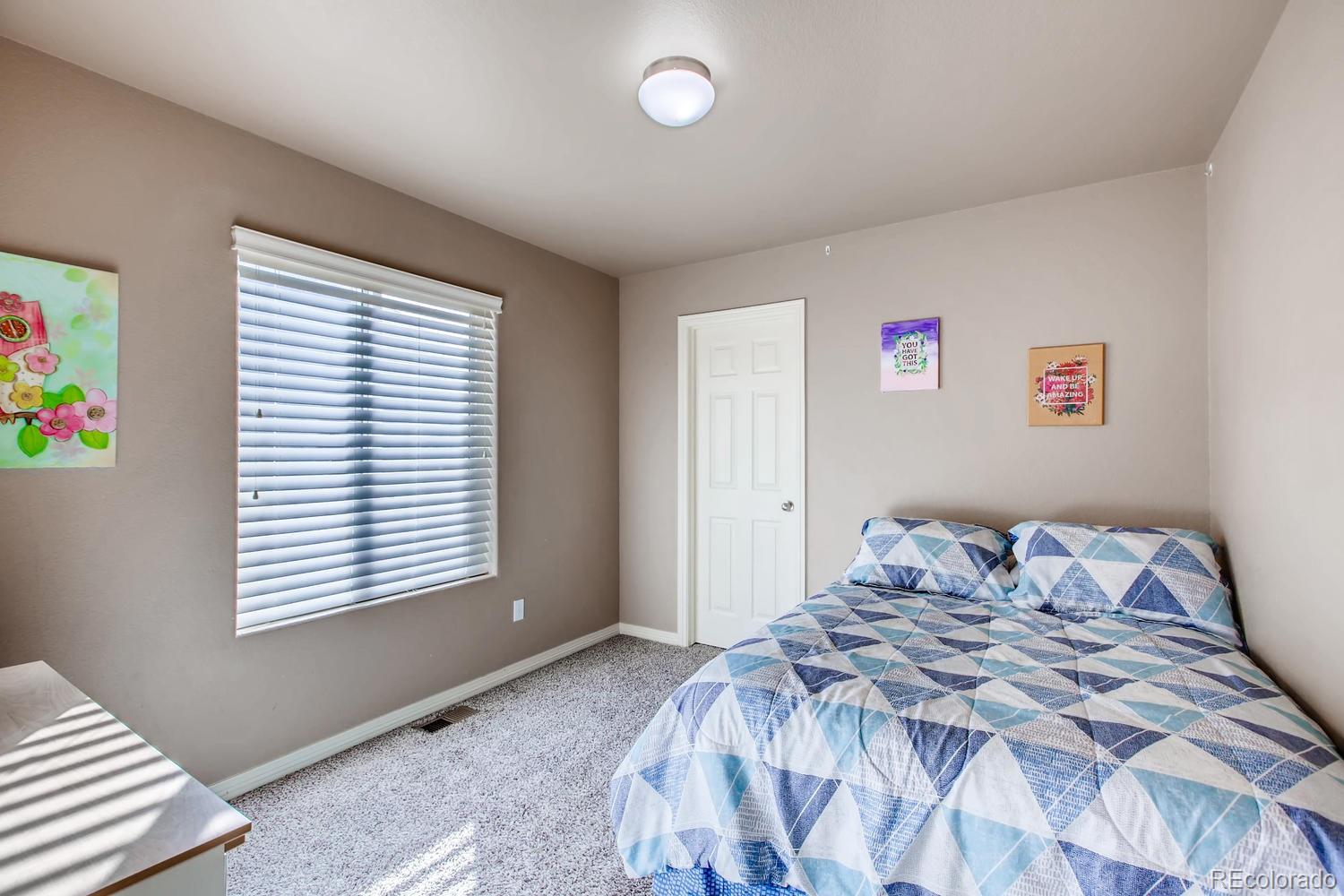 2184 Reed Grass Way Colorado Springs, CO 80915 - Photo 23 of 29 a bedroom with a bed and a window