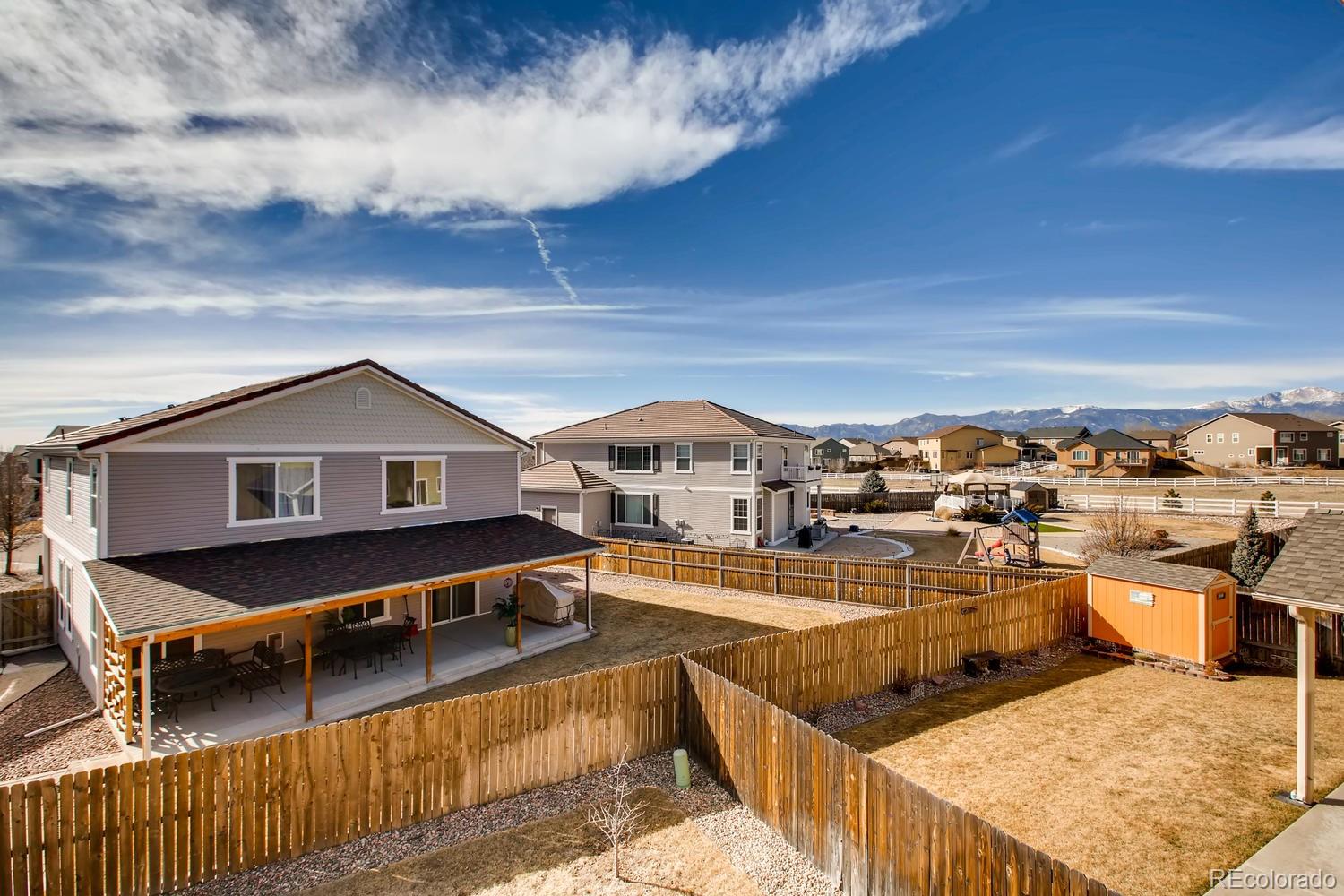 2184 Reed Grass Way Colorado Springs, CO 80915 - Photo 28 of 29 a view of a terrace with wooden fence