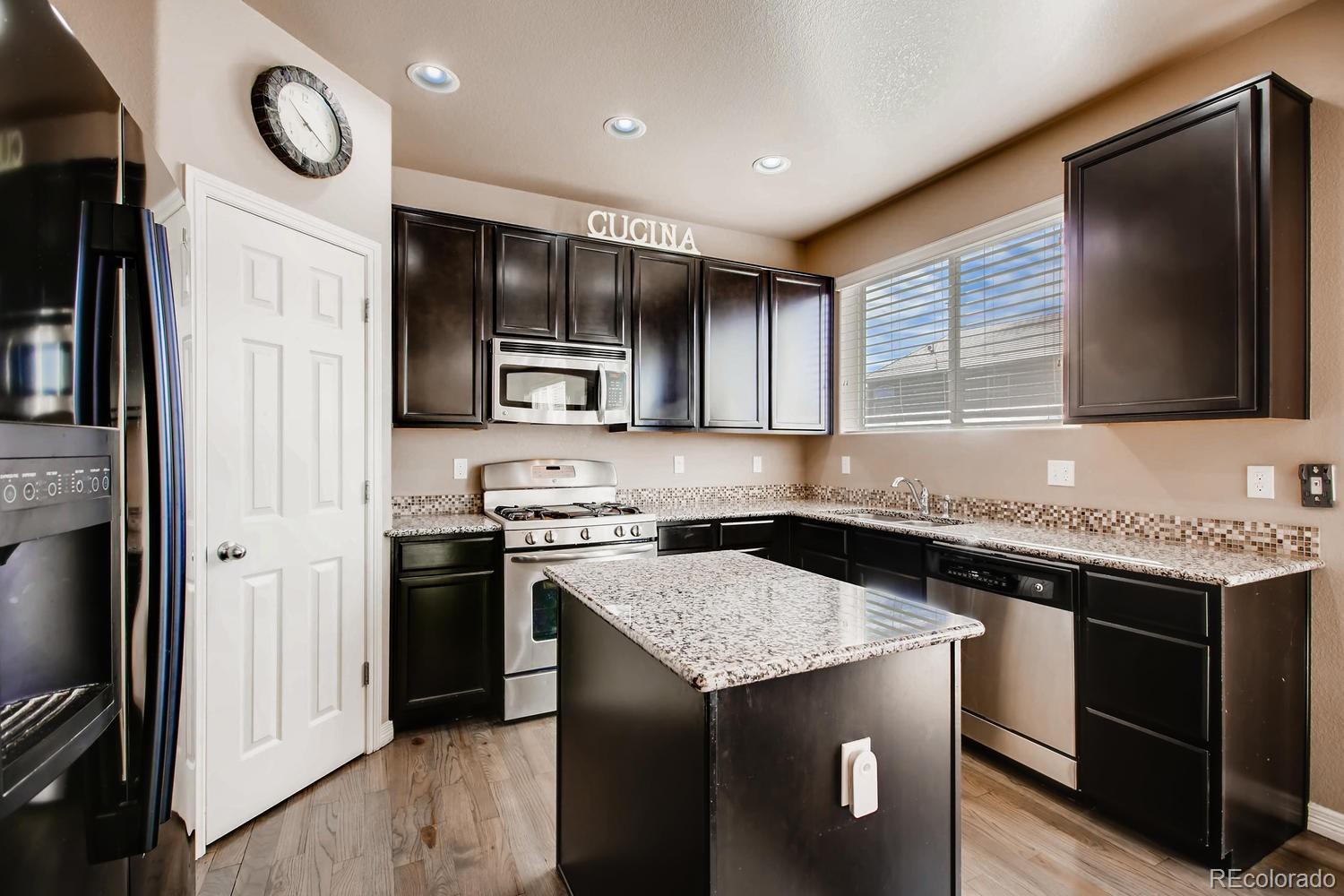 2184 Reed Grass Way Colorado Springs, CO 80915 - Photo 4 of 29 a kitchen with a stove and a microwave