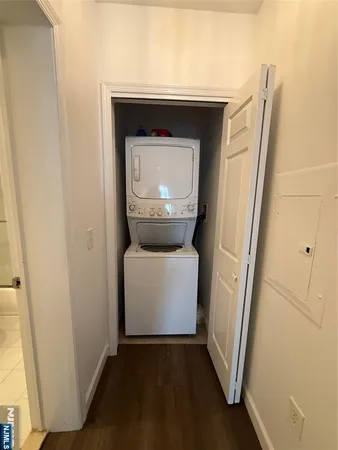a utility room with wooden floor washer and dryer
