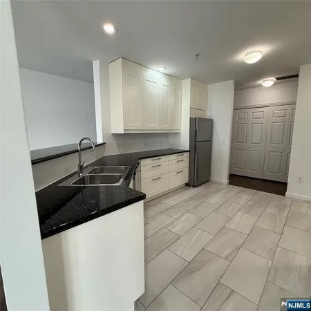 a kitchen with a sink and a refrigerator