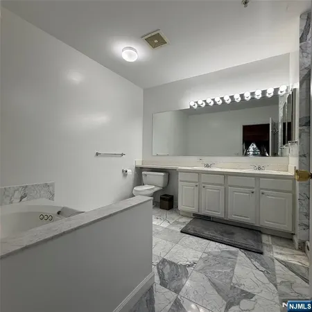 a bathroom with a sink double vanity and a mirror