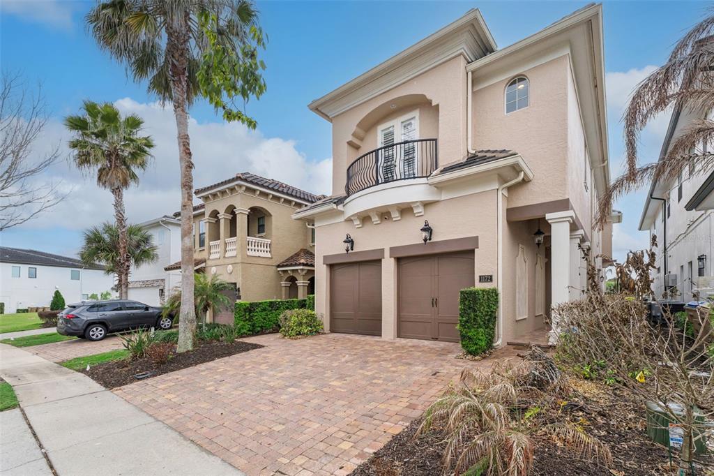 1172 Castle Pines Court Reunion, FL 34747 - Photo 11 of 65 a front view of a house with a yard and garage