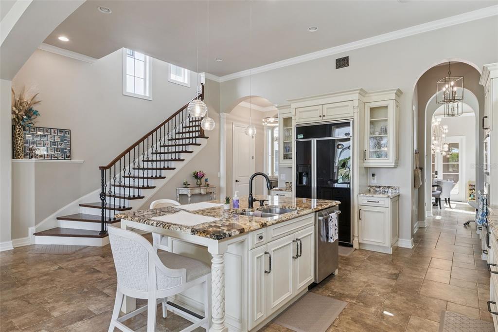 1172 Castle Pines Court Reunion, FL 34747 - Photo 18 of 65 a kitchen with stainless steel appliances kitchen island a chandelier