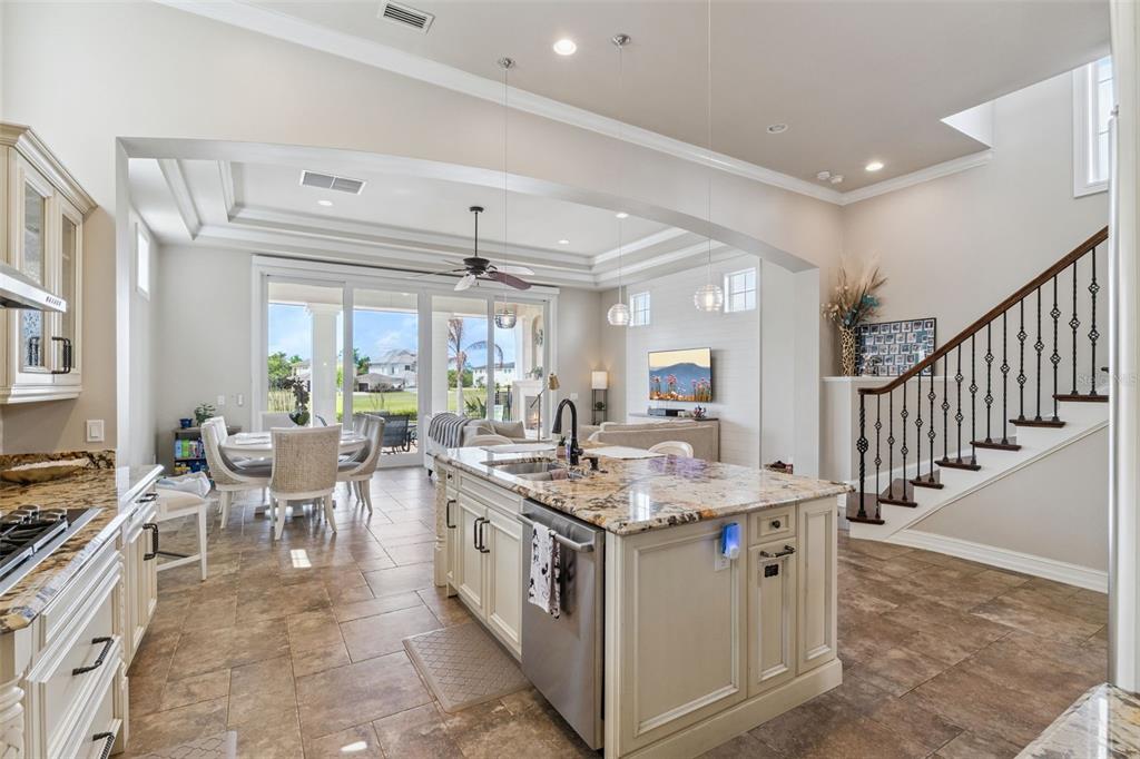 1172 Castle Pines Court Reunion, FL 34747 - Photo 23 of 65 a open kitchen with stainless steel appliances granite countertop a sink and stove