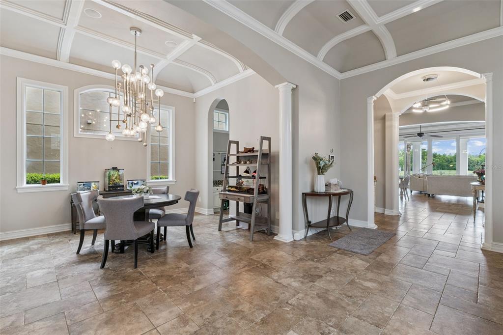 1172 Castle Pines Court Reunion, FL 34747 - Photo 27 of 65 a view of a dining room with furniture and chandelier