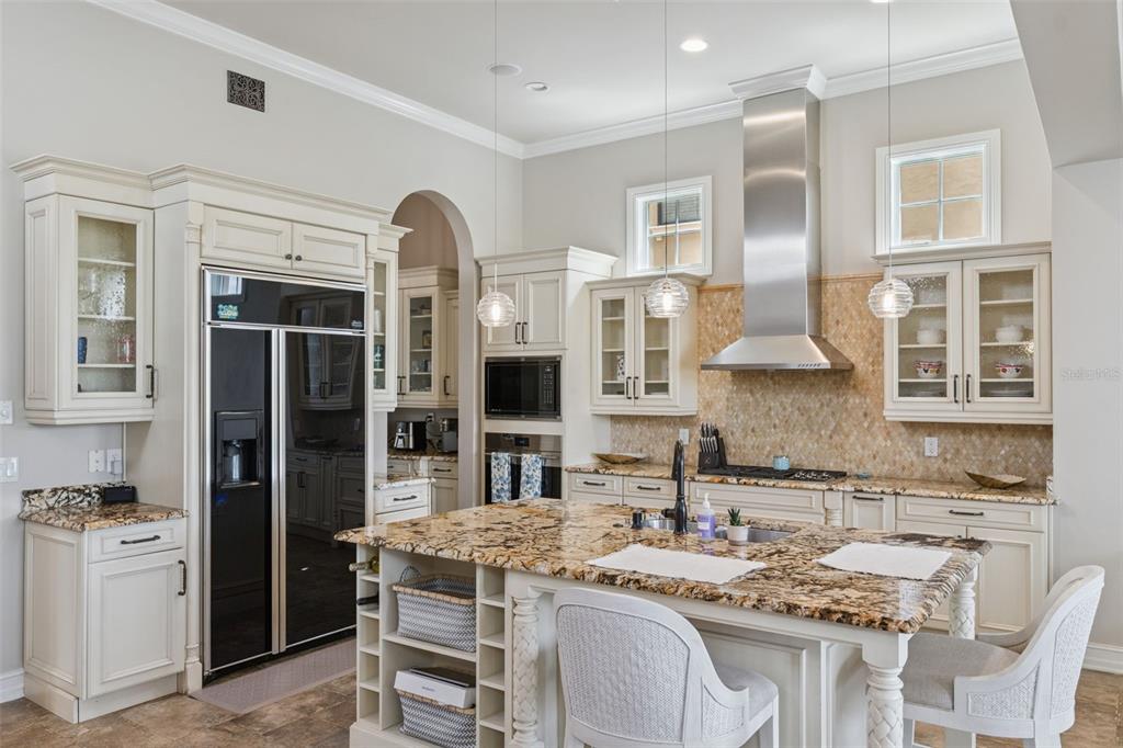 1172 Castle Pines Court Reunion, FL 34747 - Photo 28 of 65 a kitchen with stainless steel appliances granite countertop a stove and cabinets