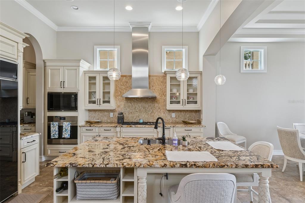 1172 Castle Pines Court Reunion, FL 34747 - Photo 29 of 65 a kitchen with stainless steel appliances kitchen island granite countertop a sink and cabinets