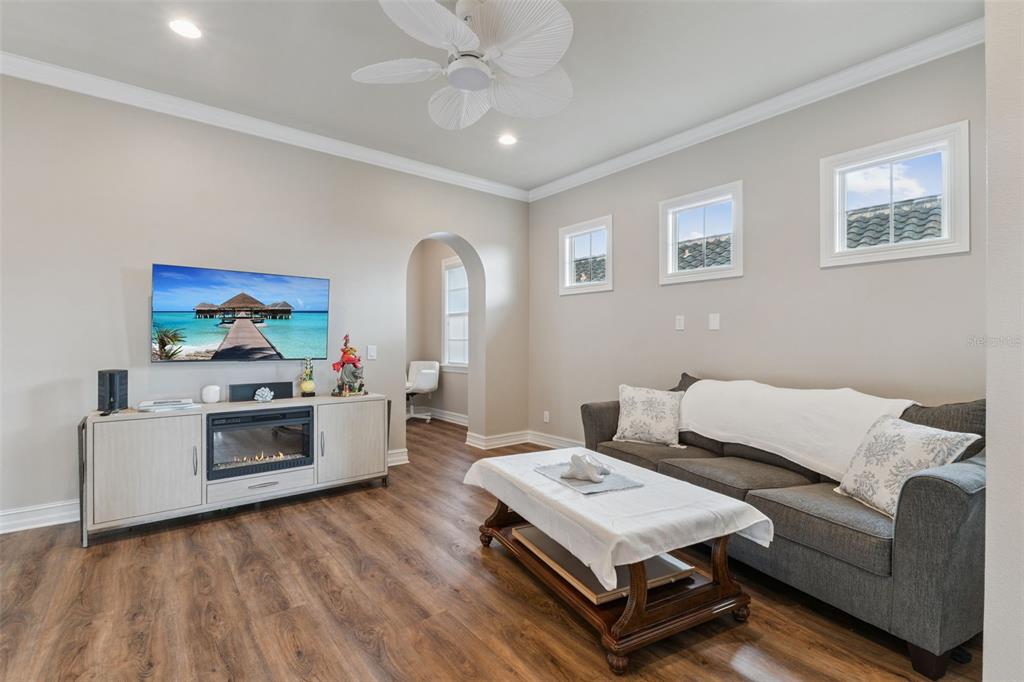 1172 Castle Pines Court Reunion, FL 34747 - Photo 31 of 65 a living room with furniture and a wooden floor