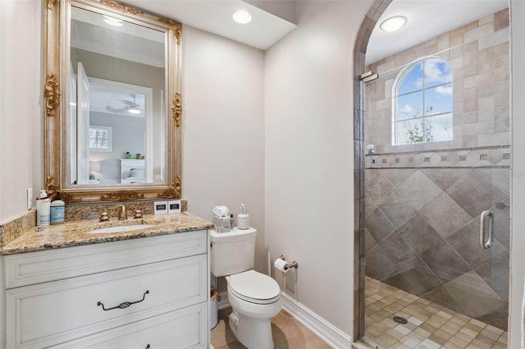 1172 Castle Pines Court Reunion, FL 34747 - Photo 34 of 65 a bathroom with a granite countertop sink toilet and shower